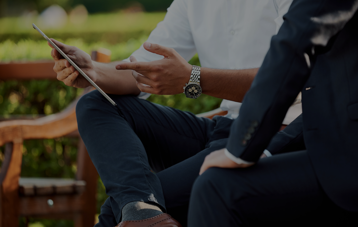 Blog background of man sharing something on phone to a friend in the outdoors