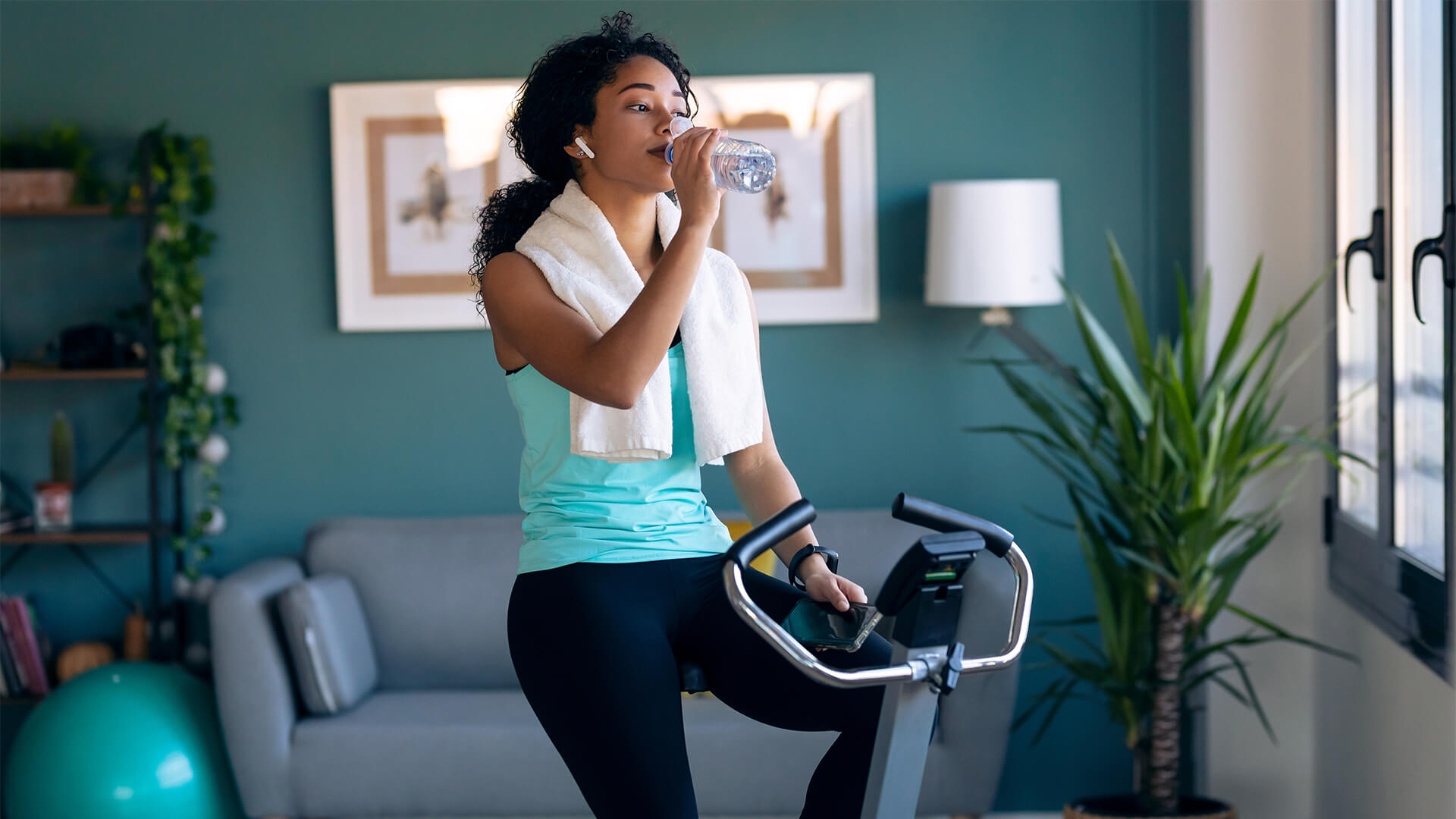 Woman working out on an exercise bike at home