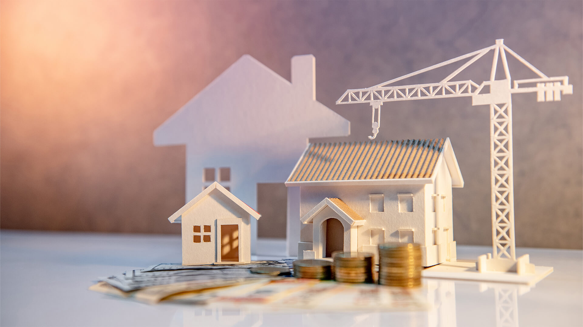 Model of houses, a crane, and money