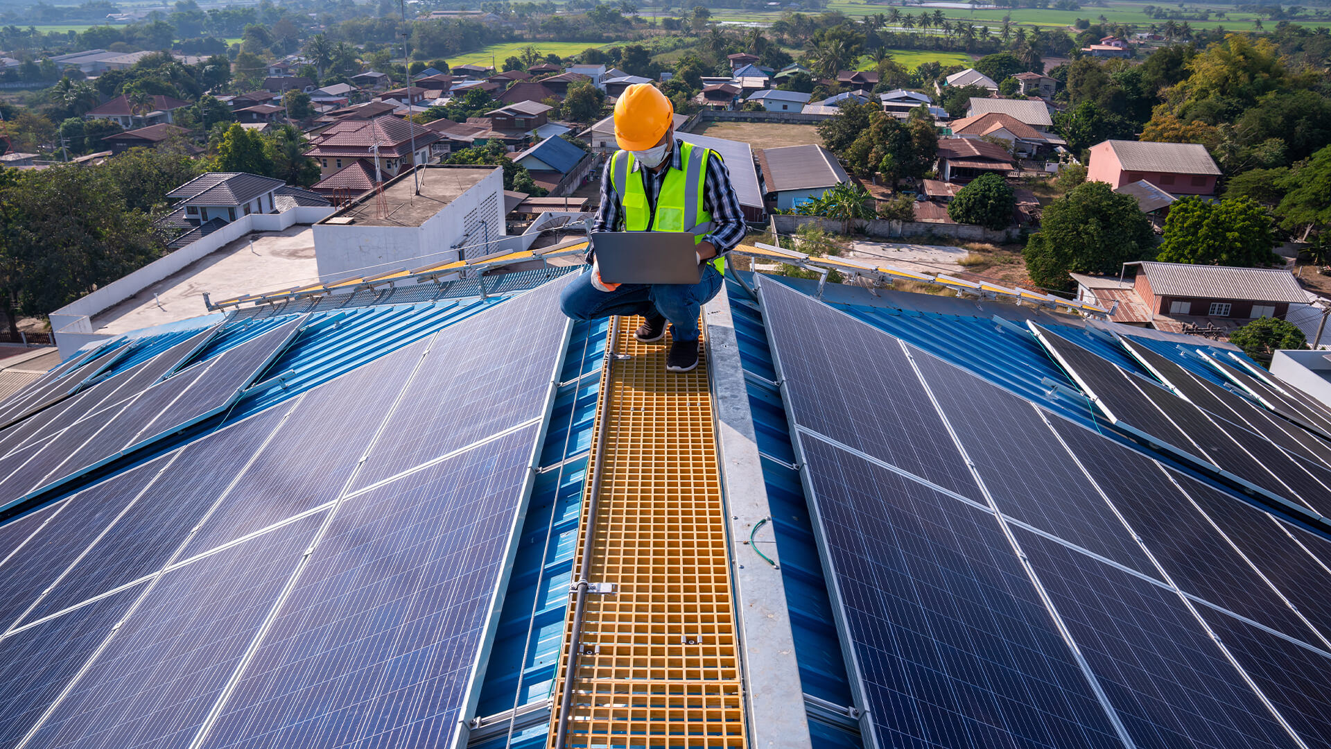 Engineer installing solar panels on a roof