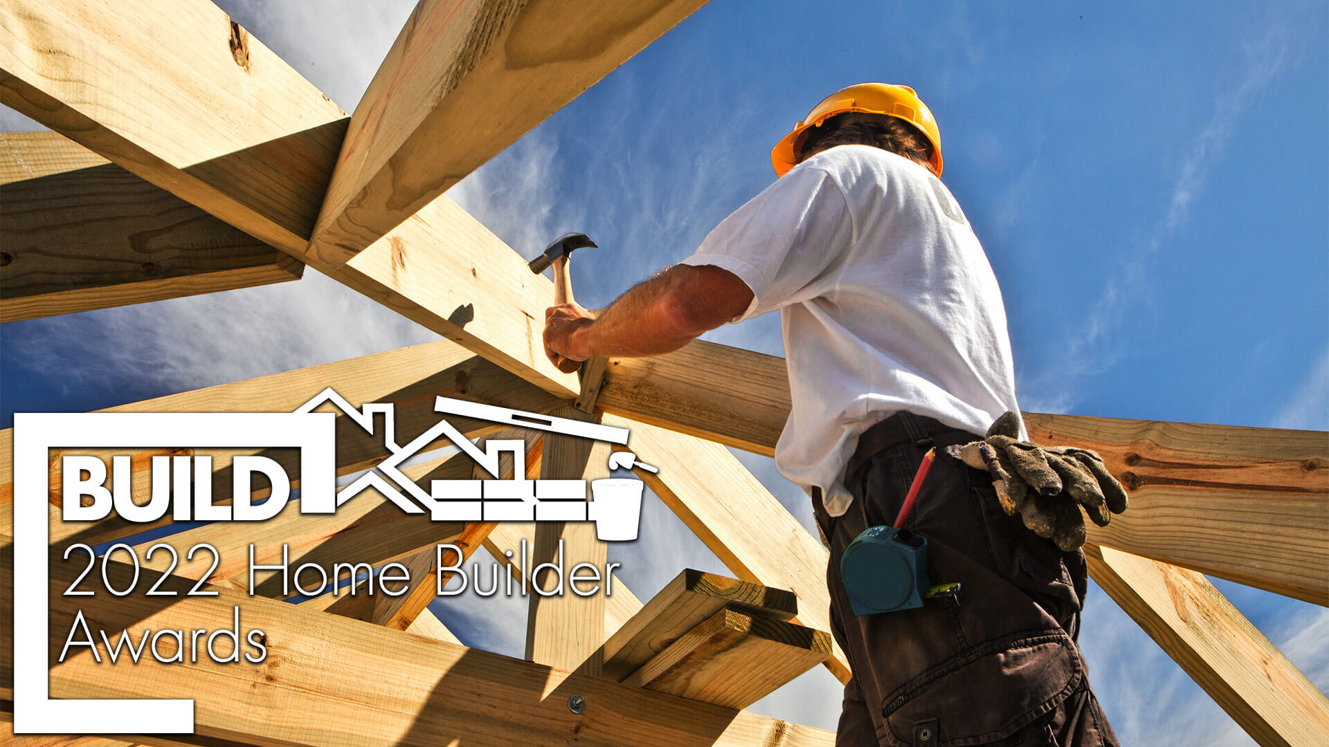 Carpenter building the wodden structure of a home. BUILD Home Builder 2022 Awards logo in the corner