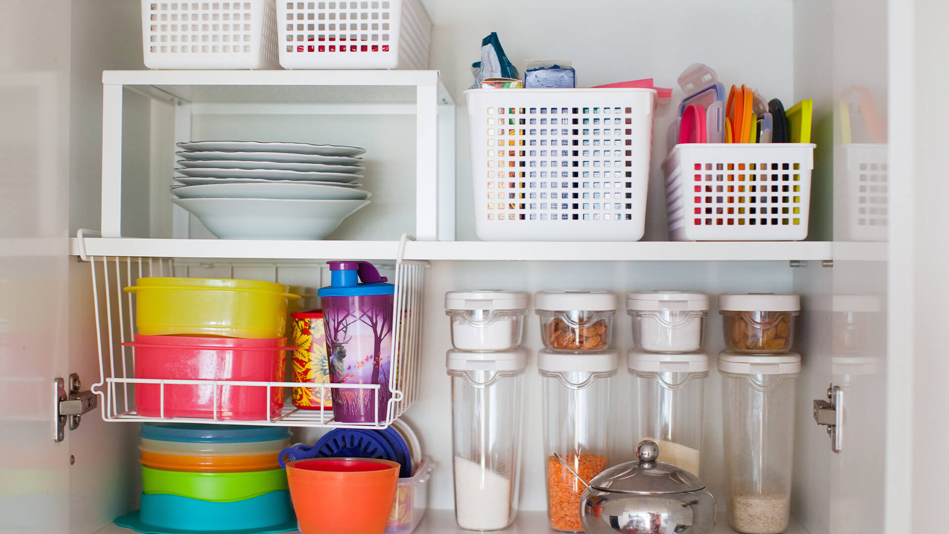 An organised kitchen cupboard with storeage containers