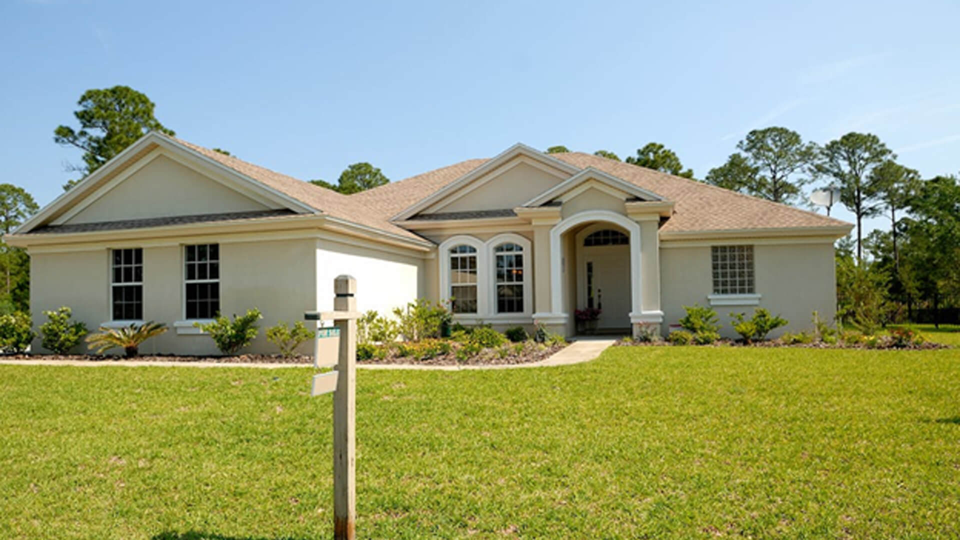 white and brown concrete bungalow under clear blue sky