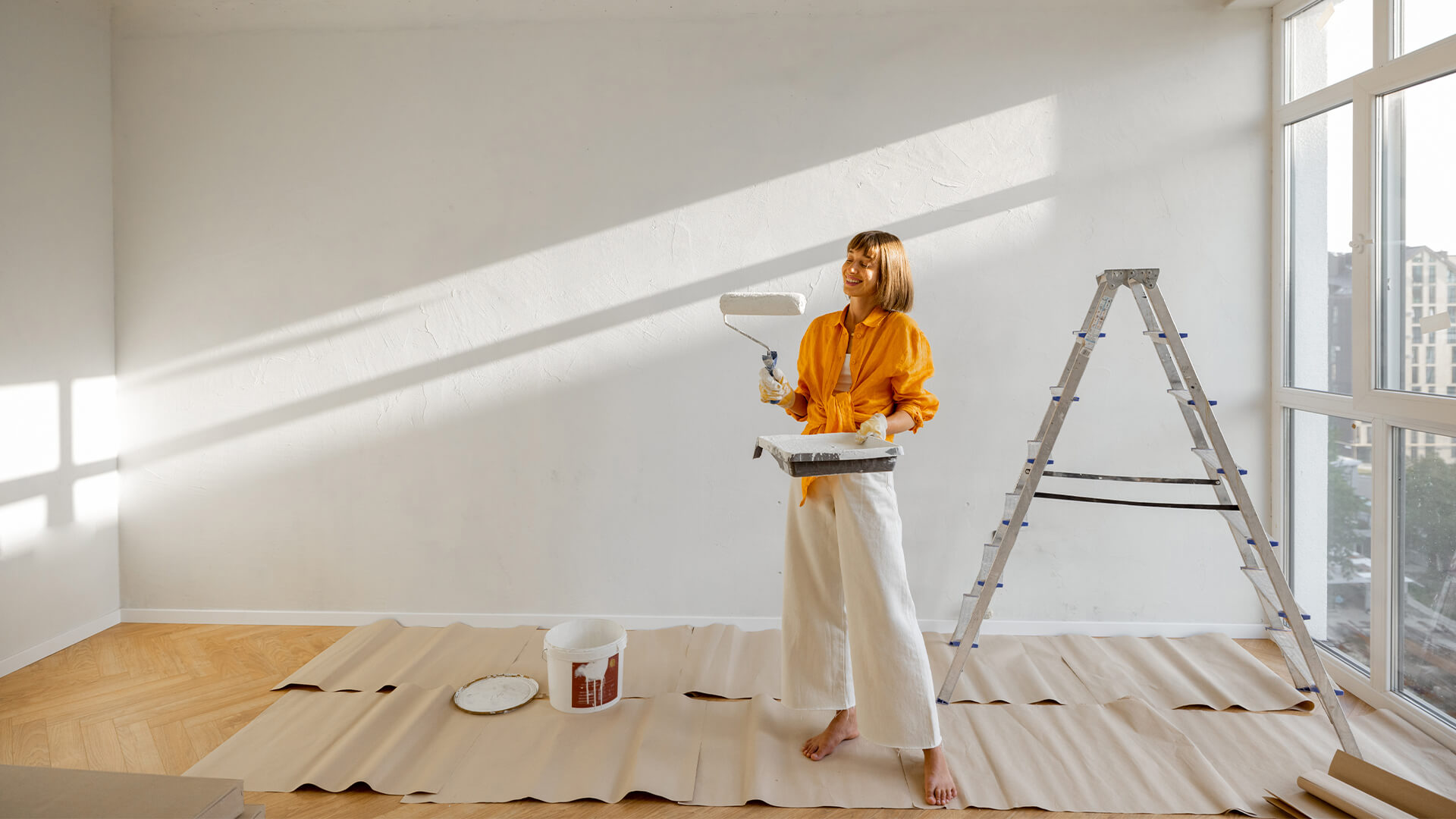 woman painting wall in house