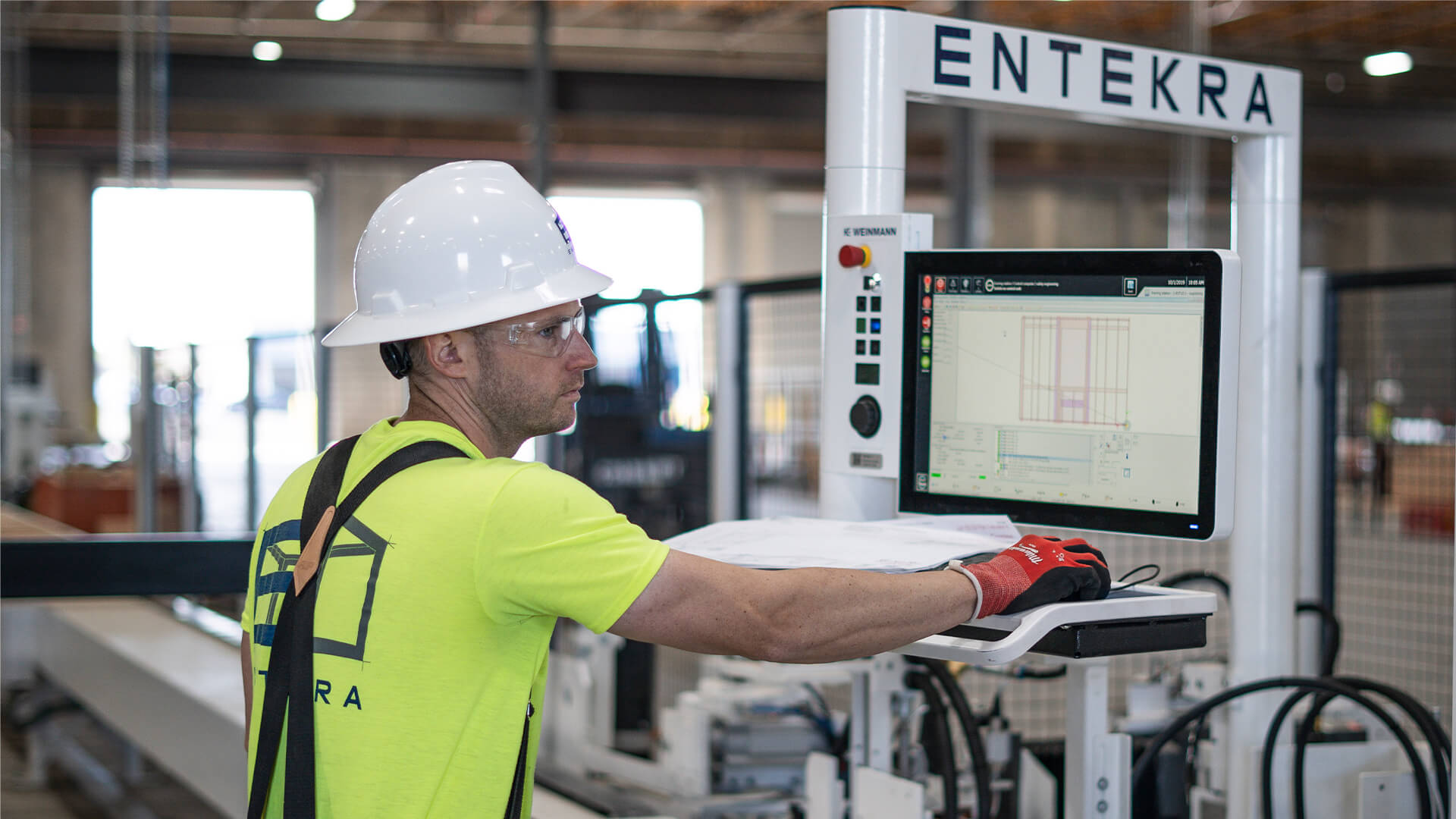 man with safety gear on using computer