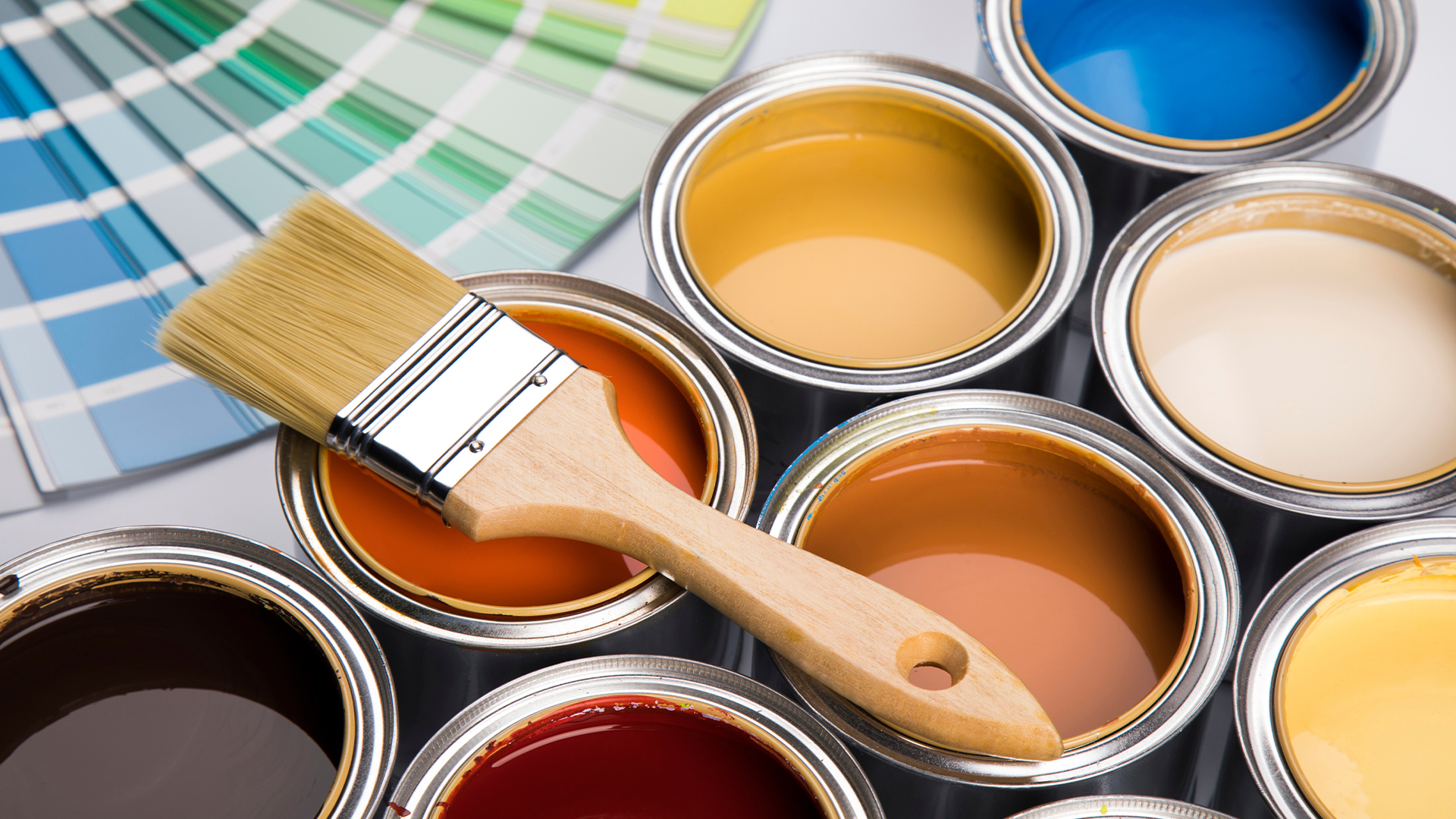 Colorful paint cans with paintbrush