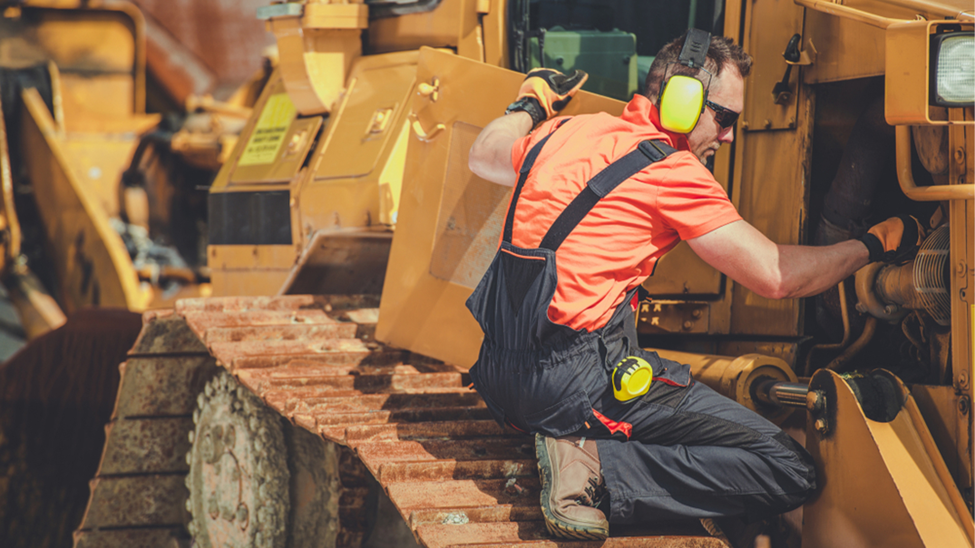 man fixing construction machine