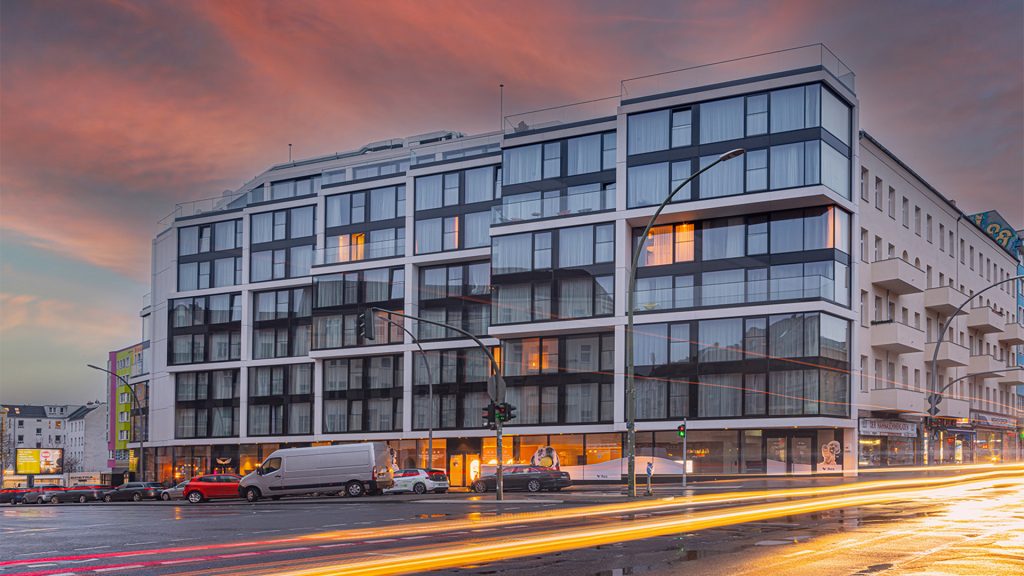 pink sunset behind modern building